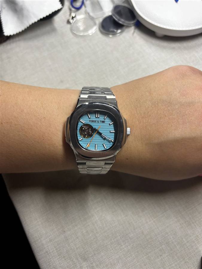A guest wearing the ice-blue open-heart watch they built