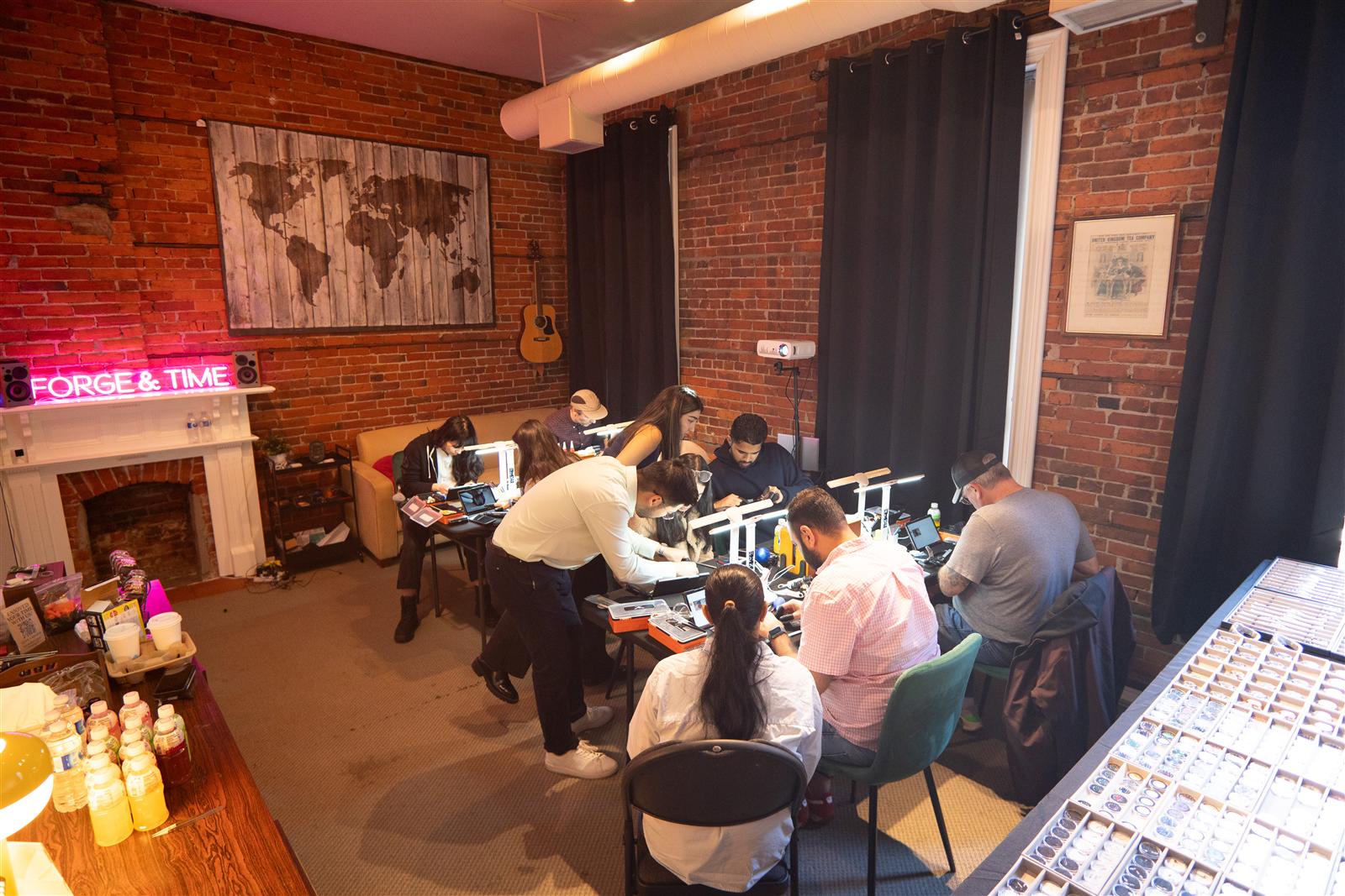 Guests building watches at the long bench in the Forge & Time studio